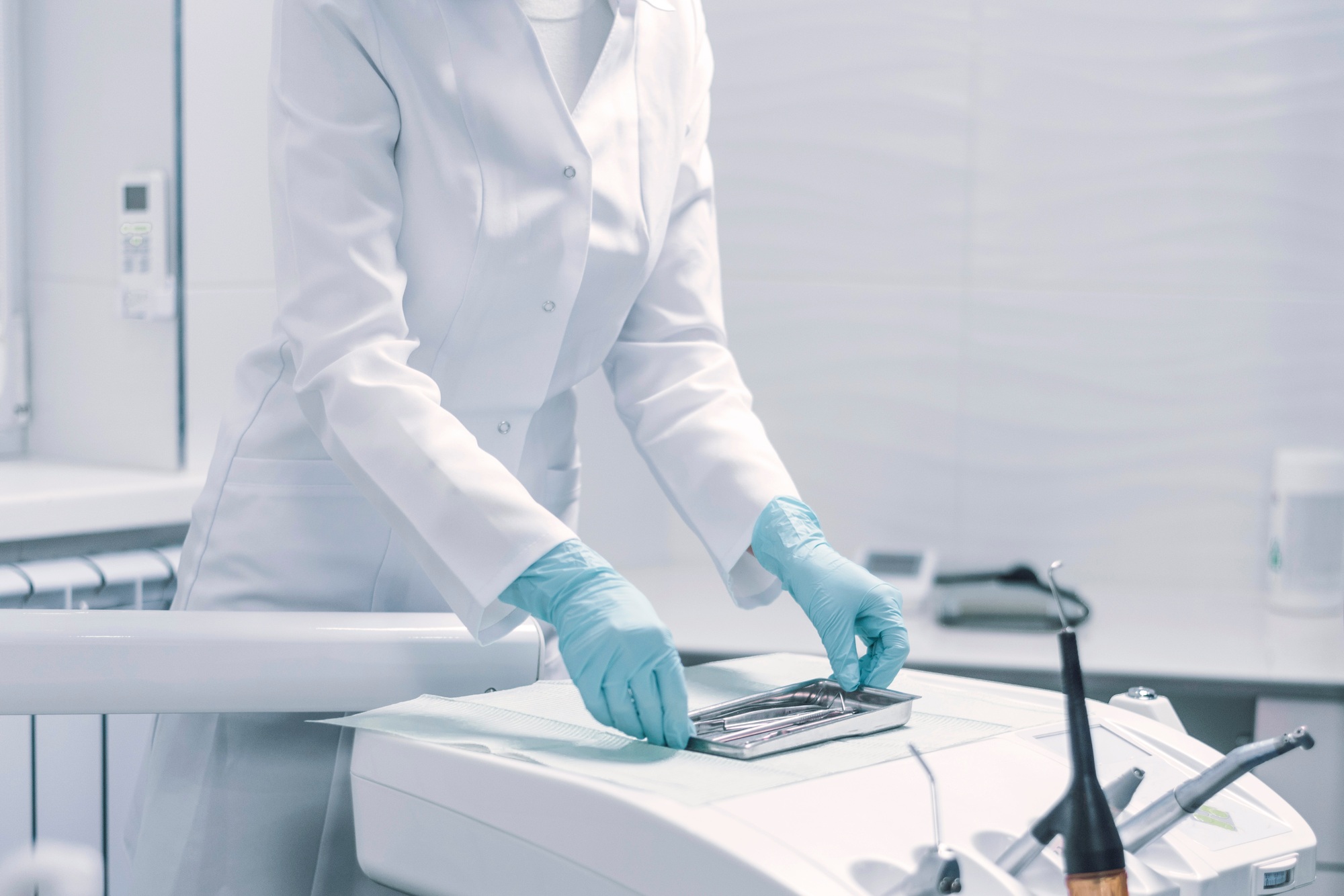 Assistant preparing the tools for teeth removal in the dentistry